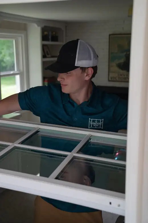 A Window Guys installer setting a new window sash